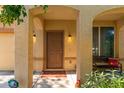 Charming covered front porch with neutral color scheme and comfortable bench seating at 10037 W Watkins St, Tolleson, AZ 85353