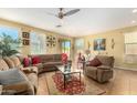 Comfortable living room with a ceiling fan and bright natural light throughout the room at 10037 W Watkins St, Tolleson, AZ 85353