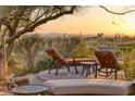 Relaxing backyard with lounge chairs, scenic desert views, and comfortable outdoor seating at 10067 E Santa Catalina Dr, Scottsdale, AZ 85255