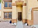 Home's arched entryway featuring detailed columns, a brown security door, and the home's address number at 10563 E Bramble Ave, Mesa, AZ 85208