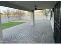 Inviting covered patio overlooking a spacious backyard with newly installed artificial turf and a paved area at 1102 W Burgess Ln, Phoenix, AZ 85041