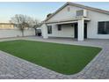 Well-maintained backyard featuring a covered patio area and newly installed artificial turf at 1102 W Burgess Ln, Phoenix, AZ 85041