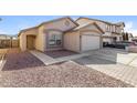 Inviting home with a two-car garage, desert landscaping, and a quaint entryway at 11829 W Rosewood Dr, El Mirage, AZ 85335