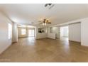 Expansive living room featuring neutral-toned walls, tile flooring, and abundant natural light at 11829 W Rosewood Dr, El Mirage, AZ 85335