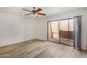 Spacious bedroom with modern flooring, ceiling fan, and a sliding glass door to a balcony at 1328 S Mckemy St, Tempe, AZ 85281