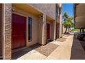 Townhouse exterior showcasing red front doors, well-kept landscaping, and stucco facade at 1328 S Mckemy St, Tempe, AZ 85281