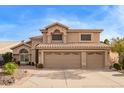 Charming two-story home with a three-car garage, desert landscaping and tile roof at 1333 E Rockledge Rd, Phoenix, AZ 85048