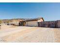 Spacious driveway leading to a charming home with solar panels, desert landscaping, and brick accents at 13425 N 16Th Ave, Phoenix, AZ 85029