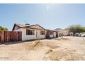 Side view of a well-maintained home with desert landscaping, privacy fence, and mountain backdrop at 13425 N 16Th Ave, Phoenix, AZ 85029