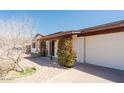 Welcoming front of home with desert landscaping, mature shrubbery and an attached two-car garage at 13425 N 16Th Ave, Phoenix, AZ 85029