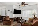 Comfortable living room featuring a ceiling fan, large window, and plush seating at 13700 N Fountain Hills Blvd # 327, Fountain Hills, AZ 85268