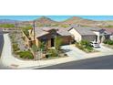 Charming exterior view of a home showcasing manicured landscaping, a two-car garage, and desert surroundings at 16788 W Beth Dr, Goodyear, AZ 85338