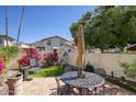 Private backyard with a tiled patio, seating, lush flowers, and mountain views at 1803 E Hayward Ave # 1, Phoenix, AZ 85020