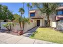 Inviting home exterior with a well-maintained lawn, mature trees, and a charming entrance at 1803 E Hayward Ave # 1, Phoenix, AZ 85020