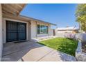 Inviting front yard featuring artificial turf, a seating area, and a decorative double-door entrance at 1830 N 87Th Way, Scottsdale, AZ 85257