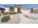 Charming single-story home with well-manicured landscaping and a two-car garage at 18430 E Azul Ct, Gold Canyon, AZ 85118