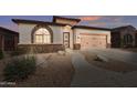 Charming single-story home with well-manicured landscaping and a two-car garage at 18430 E Azul Ct, Gold Canyon, AZ 85118