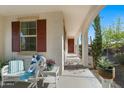 Covered patio with seating area looking onto desert landscaping at 20701 W Minnezona Ave, Buckeye, AZ 85396