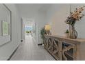 Bright hallway with neutral decor, stylish console table, and views into the open living space at 20739 W Reade Ave, Buckeye, AZ 85396