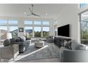 Inviting living room features neutral tones, many windows and comfortable seating around the entertainment center at 20739 W Reade Ave, Buckeye, AZ 85396