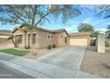 Charming single-story home with desert landscaping, a long driveway, and neutral colors at 2093 N Illinois St, Chandler, AZ 85225