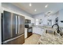 Well-equipped kitchen with stainless steel appliances, granite countertops, and white cabinetry at 2093 N Illinois St, Chandler, AZ 85225