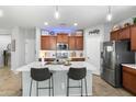 Well-lit kitchen with stainless steel appliances, marble countertops, and dark brown cabinetry at 2340 S 238Th Ln, Buckeye, AZ 85326