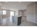 Kitchen island with gray cabinets and stone countertop, set within an open-concept layout with ample lighting at 2570 E Music Mountain Ave, Apache Junction, AZ 85119