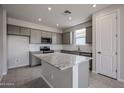 Bright kitchen featuring gray cabinets, stainless steel appliances, subway tile backsplash, and a spacious island at 2570 E Music Mountain Ave, Apache Junction, AZ 85119