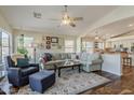 Open-concept living room featuring a plush sofa, elegant rug, and seamless transition to the kitchen, ideal for entertaining at 3116 W Folgers Rd, Phoenix, AZ 85027