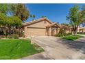 Charming single-Gathering home featuring a two-car garage, well-maintained lawn, and desert landscaping at 32 E Dawn Dr, Tempe, AZ 85284