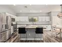 Beautiful kitchen with an island, stainless steel appliances, and white subway tile backsplash at 3213 W Desert Vista Trl, Phoenix, AZ 85083