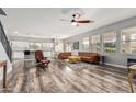 Open concept living room with modern furnishings, ceiling fan, and lots of natural light at 3213 W Desert Vista Trl, Phoenix, AZ 85083