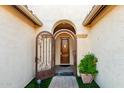 Charming front courtyard showcasing an ornate wrought iron gate and inviting curb appeal at 3234 N 163Rd Dr, Goodyear, AZ 85395