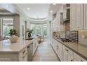 This bright, open kitchen features stainless steel appliances and a breakfast nook with backyard views at 3373 E Oriole Way, Chandler, AZ 85286