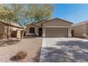 Charming single-story home with a two-car garage, desert landscaping, and covered front porch at 34969 N Open Range Dr, San Tan Valley, AZ 85144