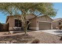 Charming single-story home with a two-car garage, desert landscaping, and covered front porch at 34969 N Open Range Dr, San Tan Valley, AZ 85144