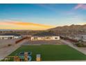 Aerial view of the backyard of the home featuring a playground and turf area at 35150 N Bell Rd, Queen Creek, AZ 85144