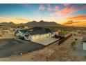 Aerial view of the home showcasing the three-car garage, and mountain views at 35150 N Bell Rd, Queen Creek, AZ 85144