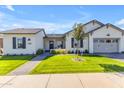 Charming single-story home featuring a well-manicured lawn and a inviting facade with a covered porch at 3547 E Bloomfield Pkwy, Gilbert, AZ 85296