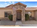 Inviting front entrance with stone accents and a cozy bench at 3663 E Camden Ave, San Tan Valley, AZ 85140