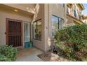 Inviting front entrance features a secure screen door, charming potted plants, and updated windows at 500 N Roosevelt Ave # 102, Chandler, AZ 85226