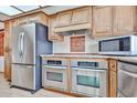 Modern kitchen with stainless steel appliances and custom cabinetry, ready for cooking enjoyment at 5125 W Las Palmaritas Dr, Glendale, AZ 85302