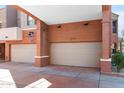 View of two car garages attached to multi-story townhomes at 605 S Roosevelt St, Tempe, AZ 85281