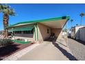 Charming home featuring a covered carport, desert landscaping, and a welcoming front entrance at 7300 N 51St Ave # G142, Glendale, AZ 85301