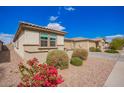 Low angle shot of a single story home with a well maintained front yard at 8146 W Sands Rd, Glendale, AZ 85303