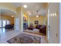 Inviting living room features a beautiful fireplace, tile floors, and arched doorways at 8715 S Valley Vista Ct, Casa Grande, AZ 85193