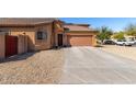 Home exterior displaying the driveway, desert landscaping, and a two-car garage at 913 W Jessica Ln, Phoenix, AZ 85041