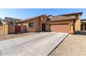 Front exterior showcasing the garage and a desert rock yard with a stone driveway and pathway at 913 W Jessica Ln, Phoenix, AZ 85041