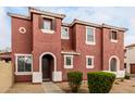 Attractive two-story home with a terracotta facade, arched doorway and shuttered windows at 924 E Redondo Dr, Gilbert, AZ 85296